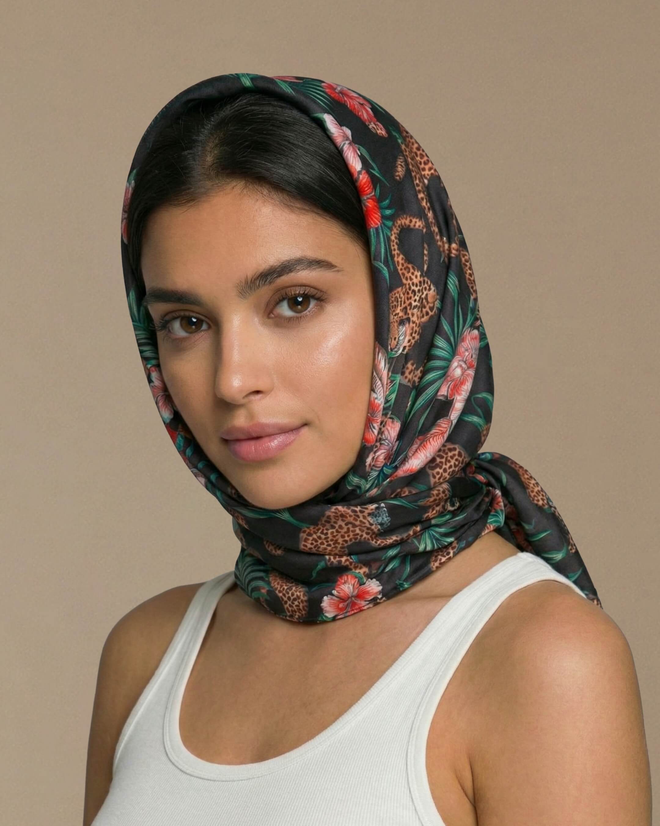 Woman wearing a floral headscarf against a beige background